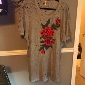 A distressed tee shirt dress w/ a floral appliqué